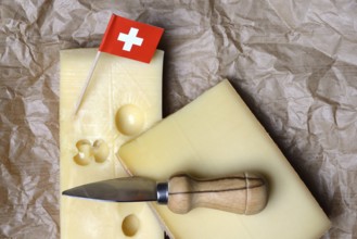 A piece of Swiss Emmental cheese and the Swiss flag
