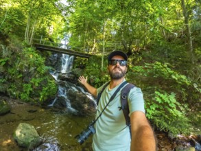 Selfie of a man tourist hiker in summer at Todtnau waterfall in Black Forest in Germany