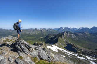 View of mountain landscape, mountain panorama, mountaineer at the summit of Rundfjellet, lake