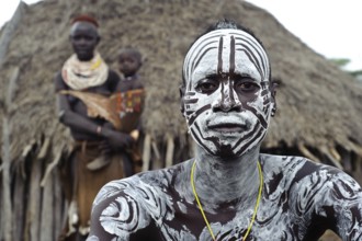 Portrait of a husband and wife and child from the Karo tribe, Omo valley, Ethiopia, Africa