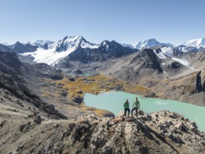 Hiker at the pass at 4000m, aerial view, mountains with glacier, mountain pass and mountain lake