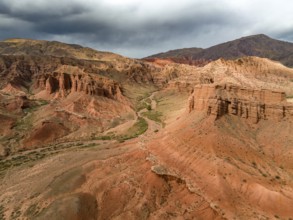 Eroded mountain landscape, canyon with red and orange rock formations, aerial view, Konorchek