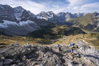 Two mountaineers on a hiking trail, mountain panorama with rocky steep peaks, view of summits