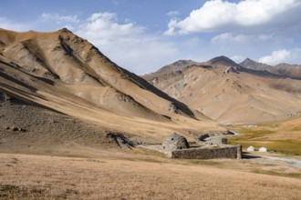 Historic caravanserai Tash Rabat from the 15th century, with yellow hills, Atbashy district in the