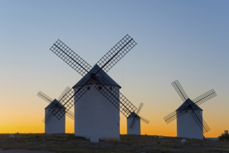 Windmills silhouetted against a soft evening sky, Campo de Criptana, Ciudad Real province,
