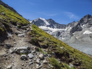 Hiking path up to mountain hut Cabane de Moiry, Moiry glacier in the back, Valais, Switzerland,