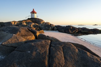 Seascape on the Lofoten Islands. The small lighthouse on the sandy beach of Eggum. Sea and rocks.