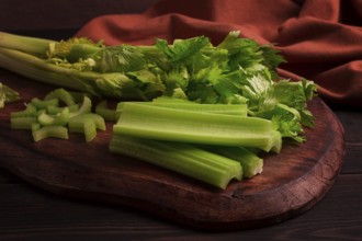 Fresh bunch of celery, top view, no people, on a dark background
