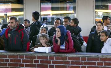 Syrian refugees arrive at Schönefeld station on a special train. They are then taken by bus to