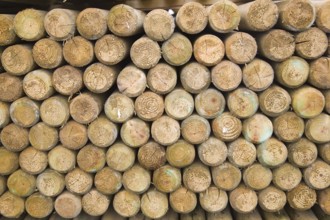 Wooden fence posts piled up in a builder's merchant yard, UK