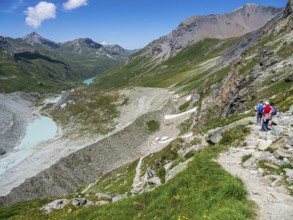 Hiking trail up to mountain hut Cabane de Moiry, glacial moraine, lake Lac de Moiry in the back,