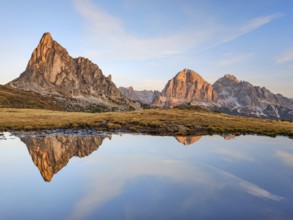 Ra Gusela in autumn, reflection, sunrise, blue sky, Passo di Giau, Dolomites, Belluno, Italy,