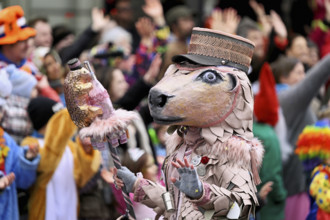 Person masked as a horse with a hat at the carnival parade of the Wey guild on Rose Monday,