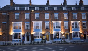 Row of guest houses and small hotels at night on the Esplanade, Weymouth, Dorset, England, United