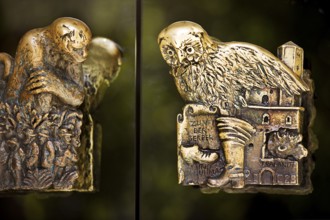 Door handles on the glass doors of the town hall with motifs from the history of the city of