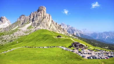 Panoramic view capturing the mountain shelter and parking area at passo giau in the italian