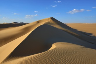 Large sand dune with soft shadows and glowing light accents in a desert landscape, Matruh, Great