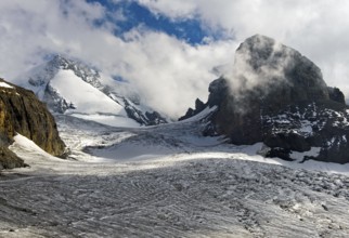 The cloud-capped Wyssi Frau peak above the Blüemlisalp glacier, Kandersteg, Bernese Oberland,