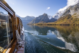 Tourist boat on the Königssee, Watzmann massif, autumnal mountain landscape reflected in the lake,