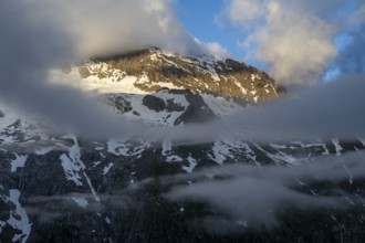 Cloudy mountain landscape in dramatic morning light, Griesferner peak with snow, Berliner Höhenweg,
