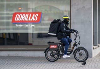 Bicycle courier from the fast delivery service Gorillas, delivers groceries, currently in over 20