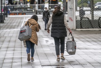 Shoppers on Kettwiger Straße, Essen city centre, with shopping bags from the Woolworth department