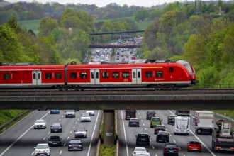 S-Bahn train crossing the motorway A3, traffic on 8 lanes, incl. the temporarily released hard