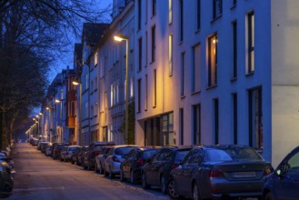 Residential street, many apartment buildings in a residential neighbourhood, evening, lantern