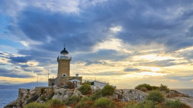 Lighthouse on rocks on the coast overlooking the sea during a picturesque sunset, lighthouse, Cape