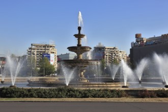 City centre, pring fountain and skyscrapers at Bulevardul Unirii, Bucharest, Romania, Europe