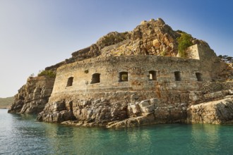 Historic rock fortress on the edge of the sea under a clear blue sky, Venetian sea fortress, Leper