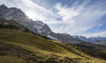 Mountain landscape with yellow meadows in autumn, summit Lamsenspitze with sun star, Karwendel,