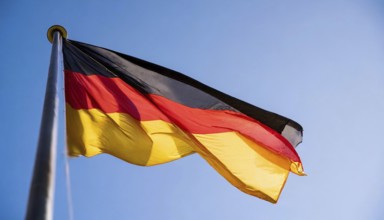 Flag, the national flag of Germany fluttering in the wind