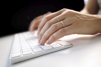 Hands typing on a keyboard in Berlin, 09/08/2024