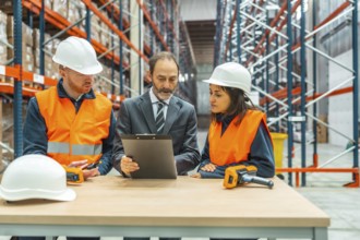 Warehouse manager presenting an inventory report on a clipboard while engaging with warehouse
