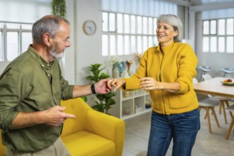 Happy and vital senior couple dancing salsa at home