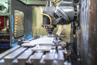 Milling machine molding shapes in metal pieces in a cnc factory with no people