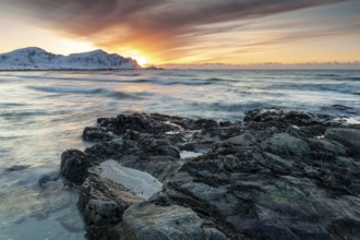 Long exposure, sunset in winter at Skagsanden, rocks on the beach at Flakstad, Flakstadøy, Lofoten,