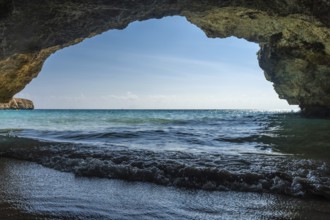 Turquoise waves gently washing onto the shore of cala domingos beach in mallorca, spain, viewed