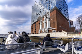 The facade of the Elbe Philharmonic Hall, tourists on a harbour ferry, Hamburg, Germany, Europe
