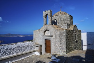 Historic chapel on a hill overlooking the sea under a clear sky, Agiou Theologou Monastery, St