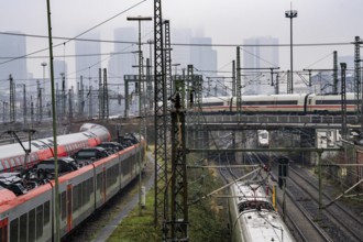 Railway tracks with regional and long-distance trains, ICE, after freezing rain, in front of