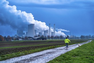 Field path, woman walking her dog, lignite-fired power plant, RWE Power AG Niederaußem power plant,