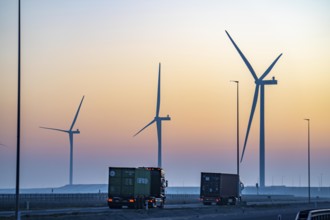 Lorry on the road from Euromax Terminal Rotterdam, ENECO wind farm on the dike around the port of