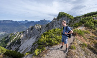 Hiker on hiking trail, Bayrischer Schinder, Tegernsee mountains in the Mangfall mountains, Germany,