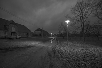 Unpaved village street in the evening, Othenstorf. Mecklenburg-Western Pomerania, Germany, Europe