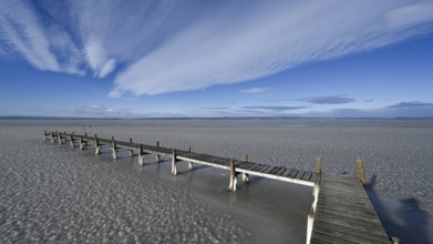 Frozen lake with ice and footbridge in winter, Lake Neusiedl, Podersdorf am See, Burgenland,