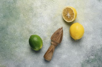 Wooden citrus reamer, manual lemon juicer, made of acacia wood, with citrus fruits on the table,