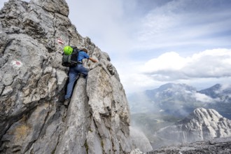 Mountaineer climbing on the rock, on a narrow rocky ridge, Watzmann crossing to the Watzmann