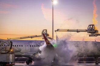 Frost at the airport, a Turkish Airlines aircraft is de-iced in front of sunrise. Airbus A321-231,